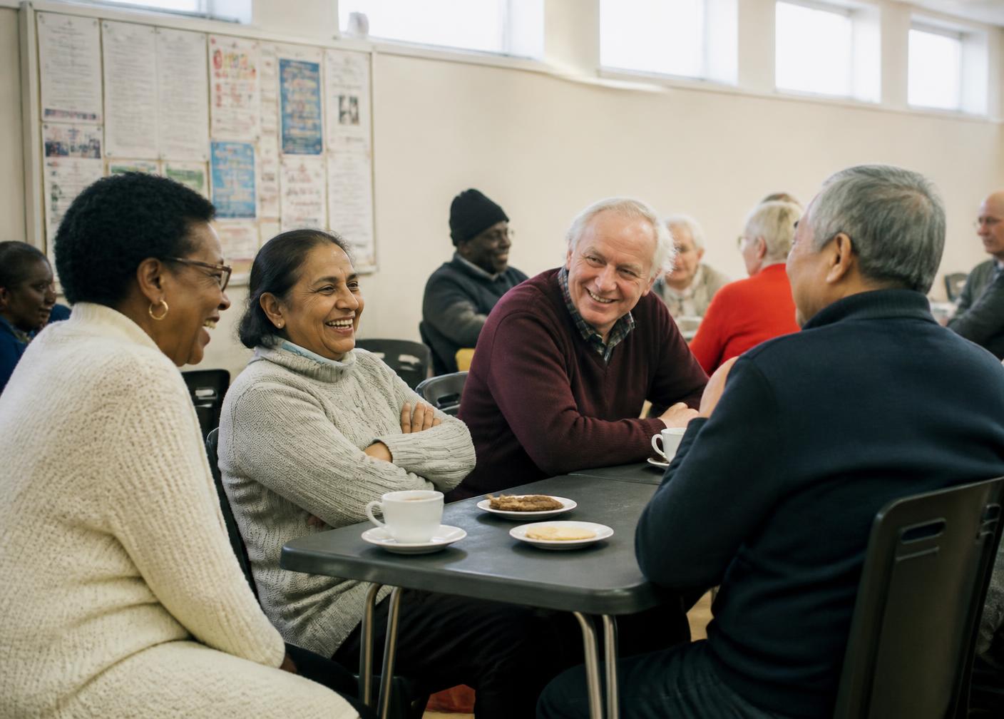 Older people from diverse London communities sharing tea together at a community centre